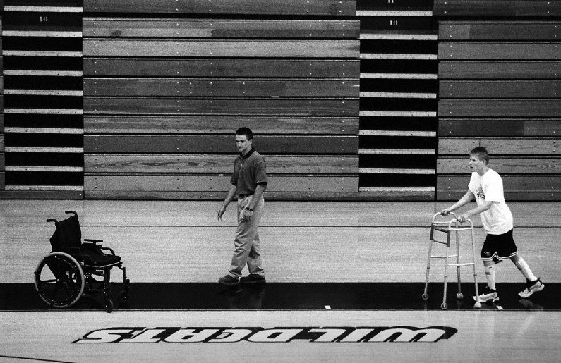 One hour of each day was spent doing some sort of physical therapy. Here, Matt rees, left, oversees jason walking around the Jasper High School gym.