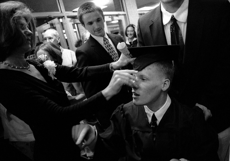 Jason's mom, Brenda Krempp, adjusted Jason's mortar board before the graduation ceremony.