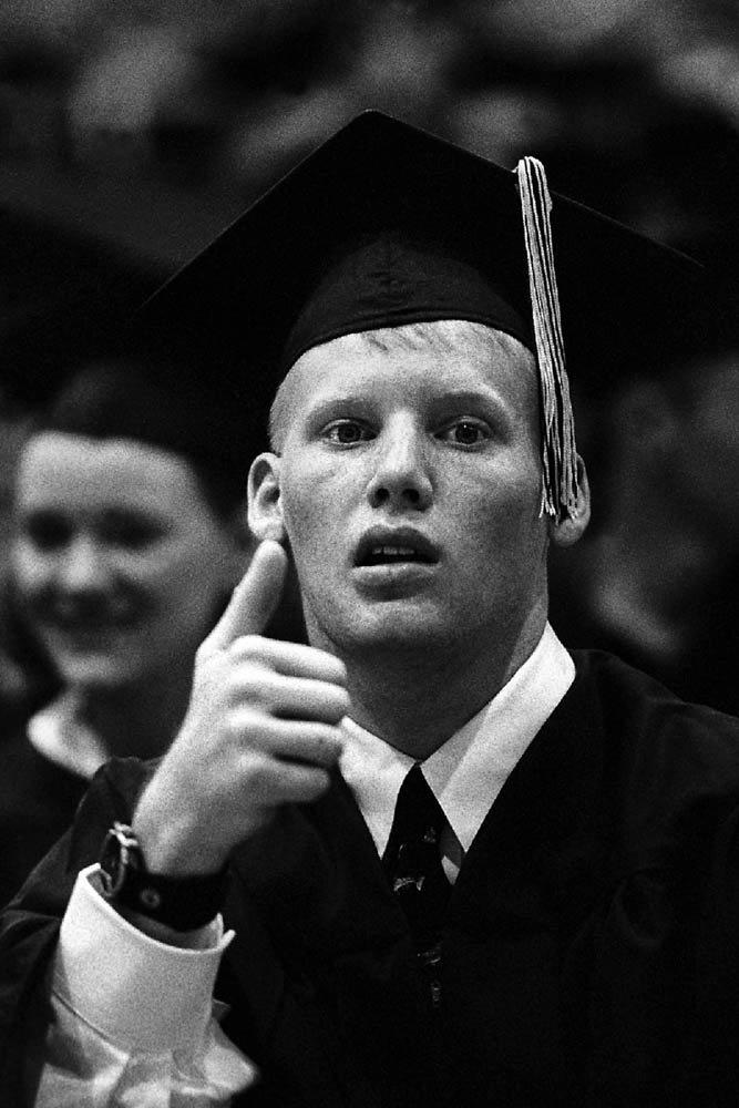 Jason communicated his happiness after receiving his diploma with a thumbs-up for family and friends.