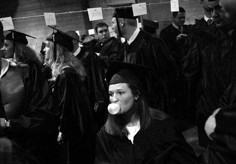 Kelly champed gum and blew bubbles while waiting backstage with fellow University of Southern Indiana graduates for the beginning of their commencement ceremony.
