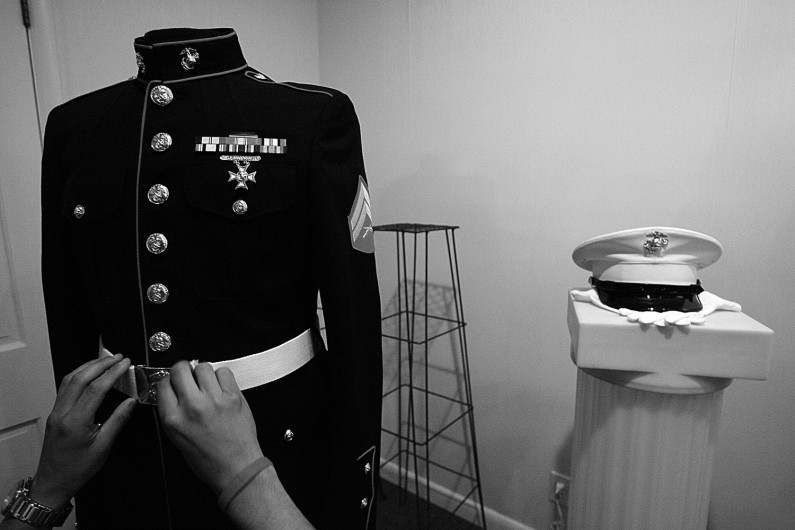 Sgt. Andre Valdez polished the buckel on a set of Eric's dress blues that was on display at the funeral home. Valdez and others spent nearly two hours on the display, making sure the buttons shined, the medals and ribbons were correctly spaced and accessories like his hat, gloves and sword were properly displayed.