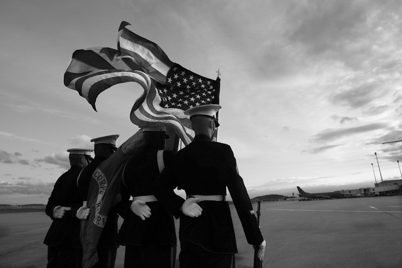 Summary: Marines do not abandon each other, which is why the corps escorts its fallen brothers all the way to their final resting places. That mission falls to the Marine Casualty Assistance Team â Marines who emphasize precision in ceremony and support for the family.  Caption:A Marine color guard stood at parade rest at sunset on May 11 as it and fellow Marines awaited the return of a fallen brother, Cpl. Eric Lueken, of Dubois, who was killed April 22  while serving in Iraq.