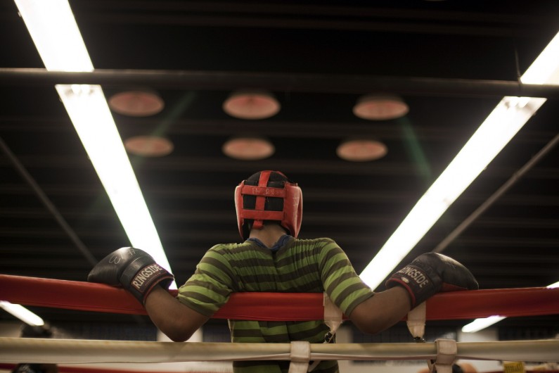 Omar Brown leans against the ropes after drills at the Harvey Boxing Club at Restoration Ministries. Brown was the first kid in the gym on this day, running several laps before his fellow club members arrived.